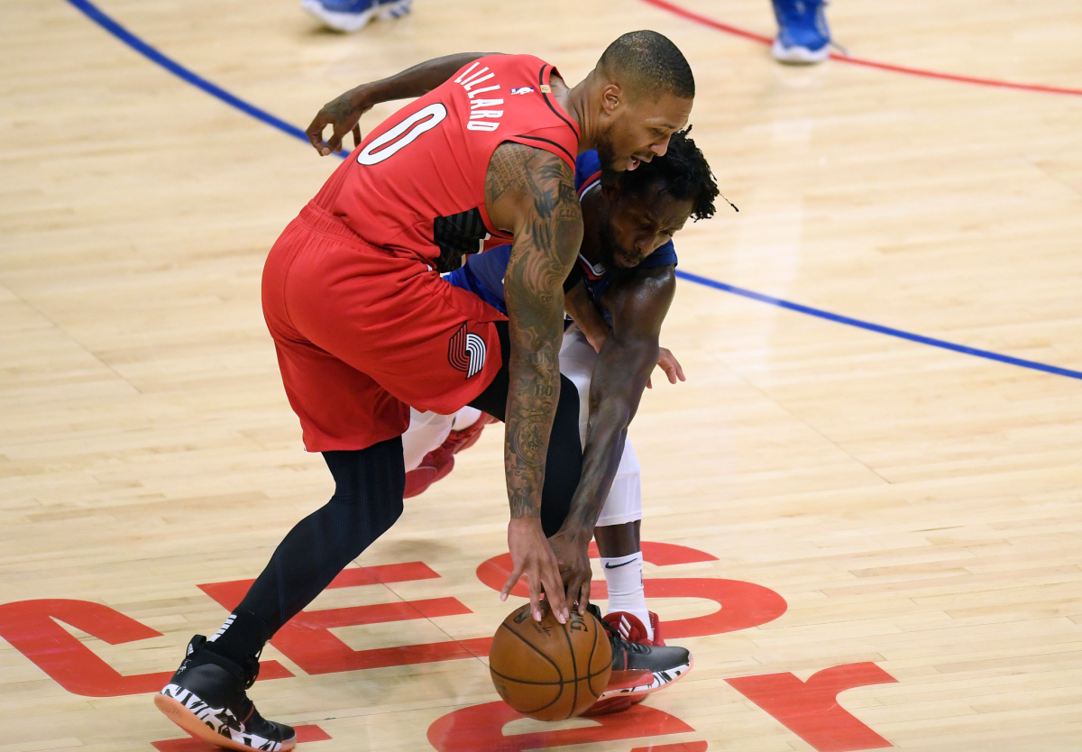 Clippers guard Patrick Beverley tries to steal the ball away from Portland Trail Blazers guard Damian Lillard.