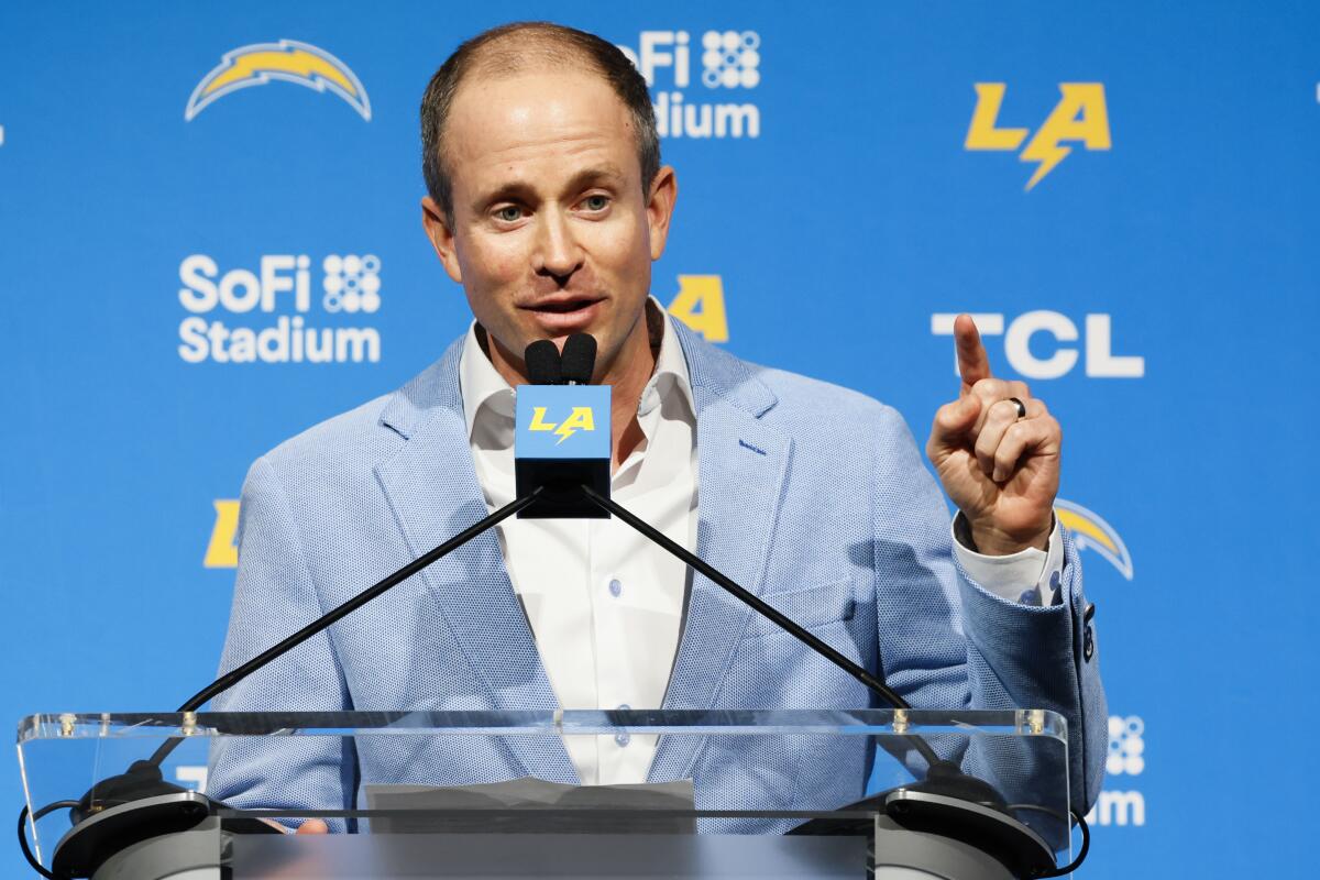 Chargers president of business operations John Spanos speaks during the introductory news conference for coach Jim Harbaugh.