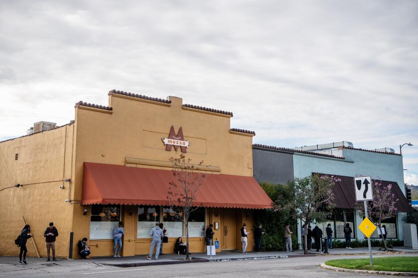 LOS ANGELES, CA- March 19, 2020: Angeleno's line the block outside Chi Spacca as Nancy Silverton and her staff prepare to offer over 300 free meals, and other supplies, to those in the restaurant industry who have been effected by closures due to the Coronavirus pandemic on Thursday, March 19, 2020. (Mariah Tauger / Los Angeles Times)