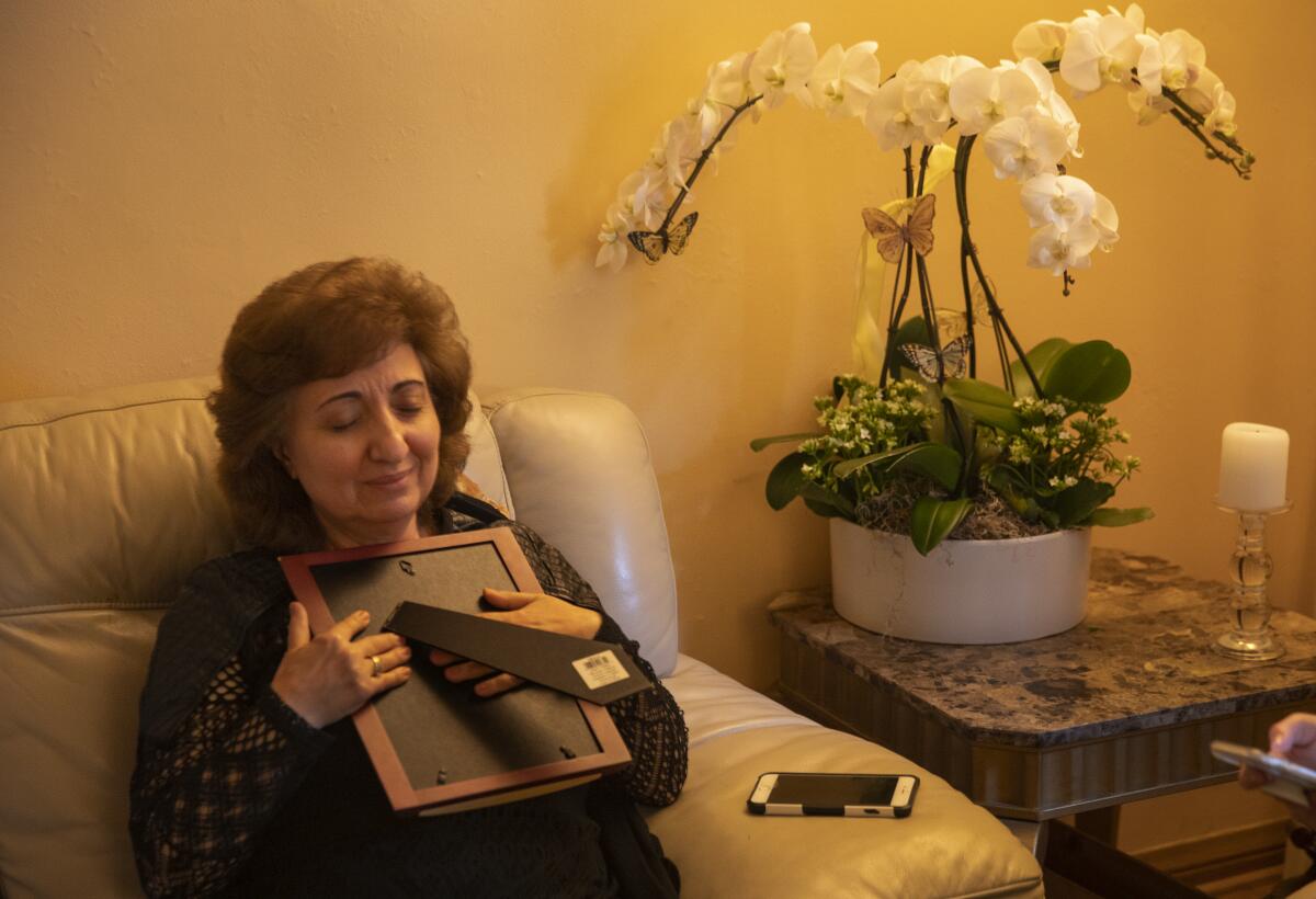  Gayane Telalyan, sister of Oganes Papazyan, 62, a cabbie who was killed last week, clutches a  photograph of her brother during a visit to his home Friday.