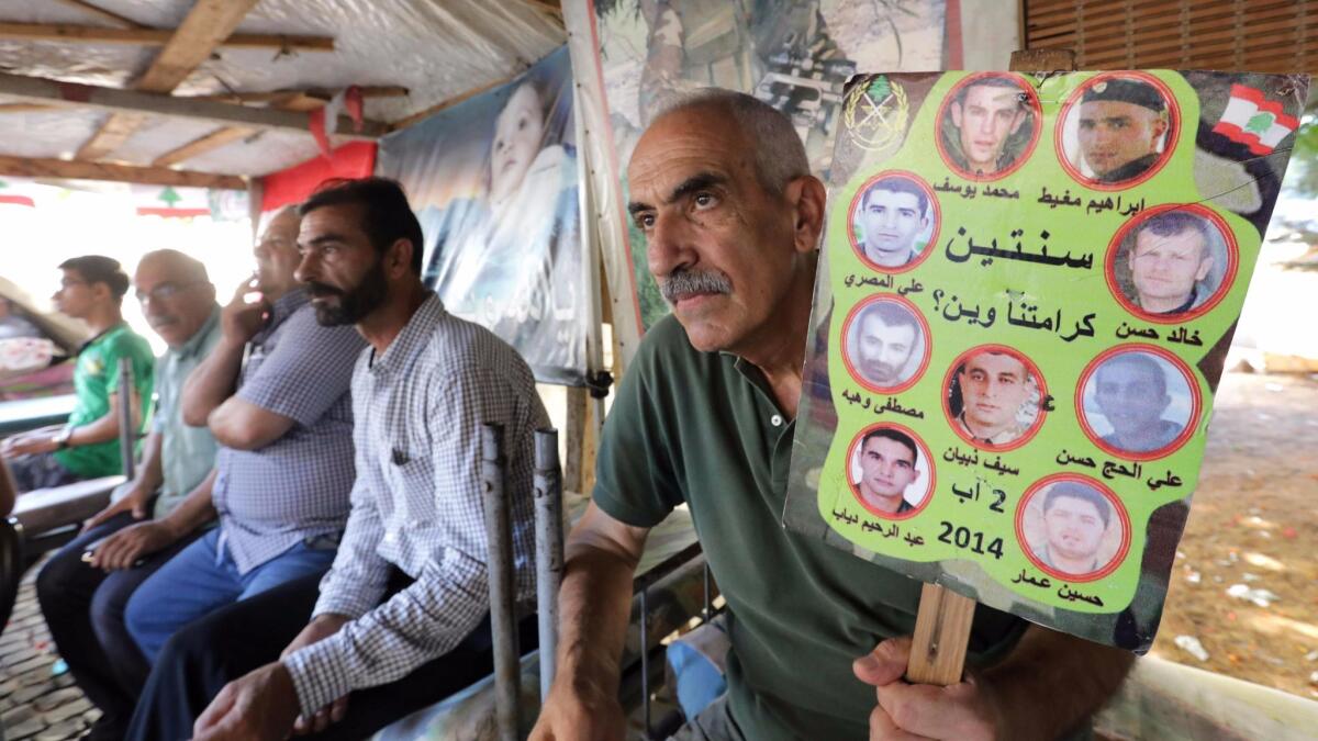 Relatives of Lebanese soldiers kidnapped by Islamic State in 2014 wait in a tent in downtown Beirut for news of their loved ones after the army announced it would pause its offensive against the militants in exchange for information about the missing troops.