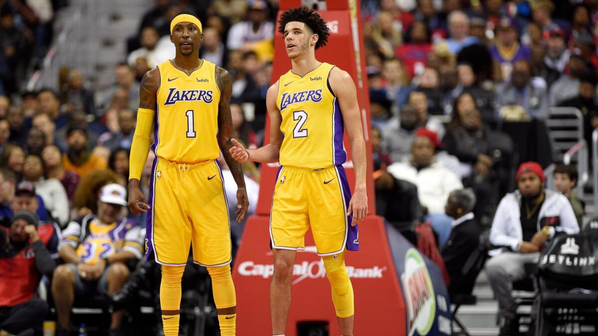 Lonzo Ball talks with Kentavious Caldwell-Pope during the first half against the Washington Wizards.