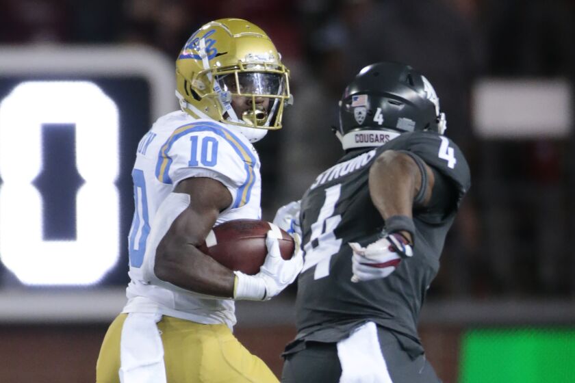 UCLA receiver Demetric Felton beats Washington State's Marcus Strong for one of his two touchdowns during the Bruins' comeback win Sept. 21 in Pullman, Wash.