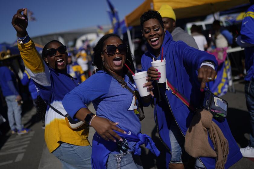 Fans tailgate before an NFL football game between the Los Angeles Rams and the Arizona Cardinals 