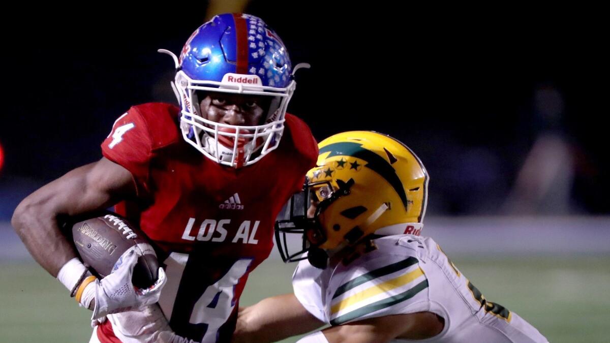 Los Alamitos High running back Oscar Brown runs the ball in a Sunset League game against Edison at Cerritos College in Norwalk on Friday.