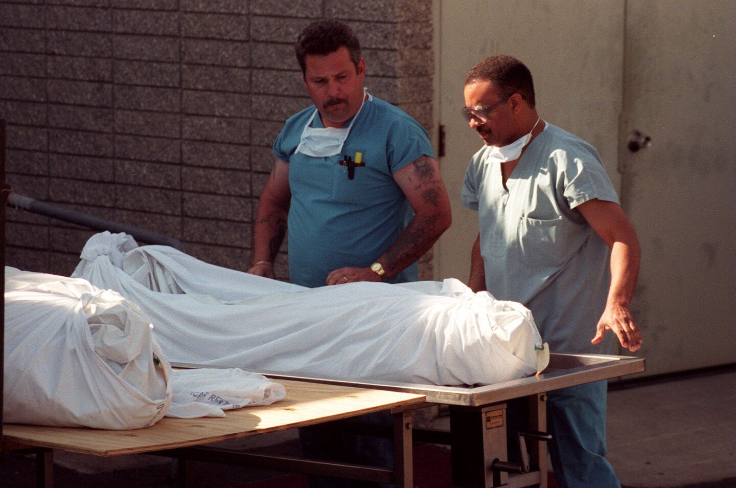 Personnel at the county Medical Examiner's Office in Kearny Mesa prepared to remove two of the 39 bodies discovered after the Heaven's Gate mass suicide in Rancho Santa Fe on March 26, 1997.