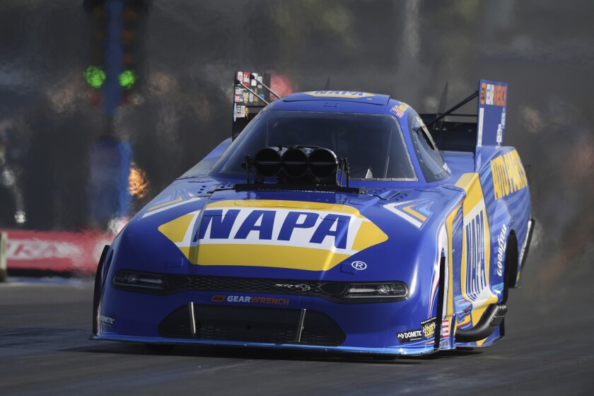 In this photo provided by the NHRA, reigning Funny Car champion Ron Capps cruises to the No. 1 qualifier position Saturday, April 2, 2022, in his hot rod at the NHRA Four-Wide Nationals at Las Vegas Motor Speedway in Las Vegas. (Marc Gewertz/NHRA via AP)