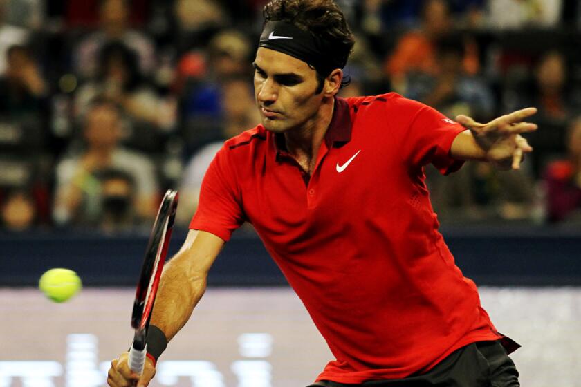 Roger Federer volleys a shot against Gilles Simon during the Shanghai Masters championship match on Sunday.