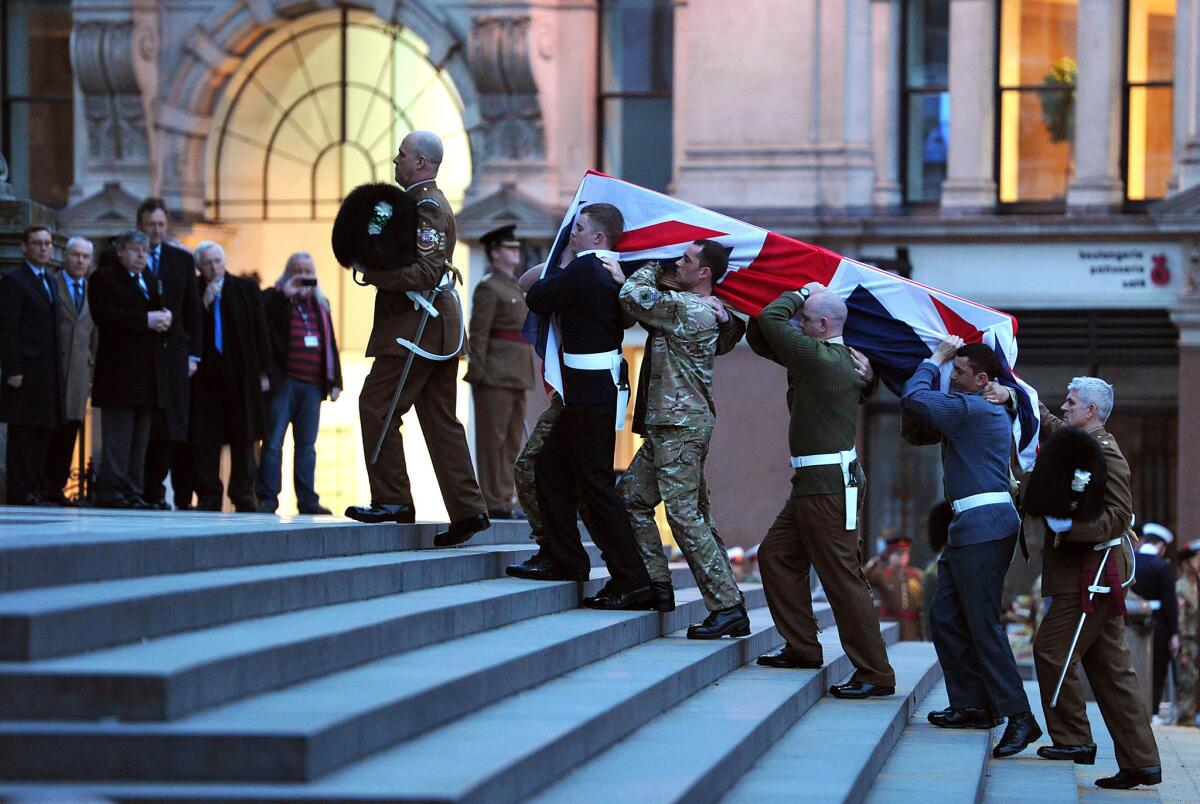 Representatives of Britain's military services carry a coffin up the steps of St. Paul's Cathedral during a rehearsal for the funeral of former Prime Minister Margaret Thatcher.