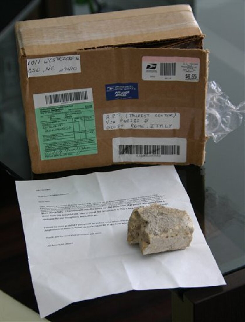 In this photo taken May 6, 2009, released Thursday May 7, 2009, by the "APT Comune di Roma" city hall tourist office in Rome, a chunk of Rome's ancient Colosseum and the package that was used to send it from the US are seen. Remorseful and anonymous, an American couple mailed back a chunk of ancient Rome to Italian authorities about 25 years after their Roman holiday. The tourists said in a letter, in foreground, tucked inside the package they mailed that they had picked up the fist-sized fragment of a slab of terracota near the Colosseum. But Rome's archaeological office said Thursday that the piece probably came from a bit farther away, the sprawling area of the Roman Forum or the ancient Palatine Hill. (AP Photo/APT Comune di Roma)