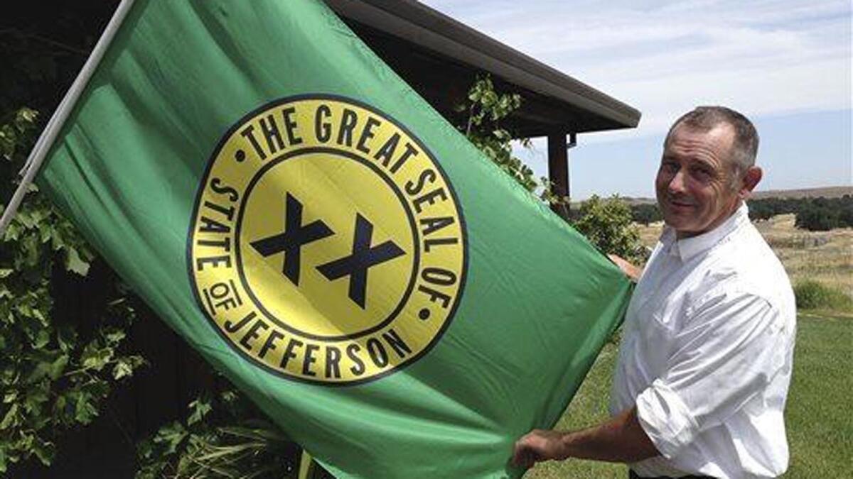 Tom Knorr, chairman of a 2014 secession campaign in Tehama County, holds the State of Jefferson flag with a logo that dates to the 1940s. There have been more than 200 secession efforts in California's history.