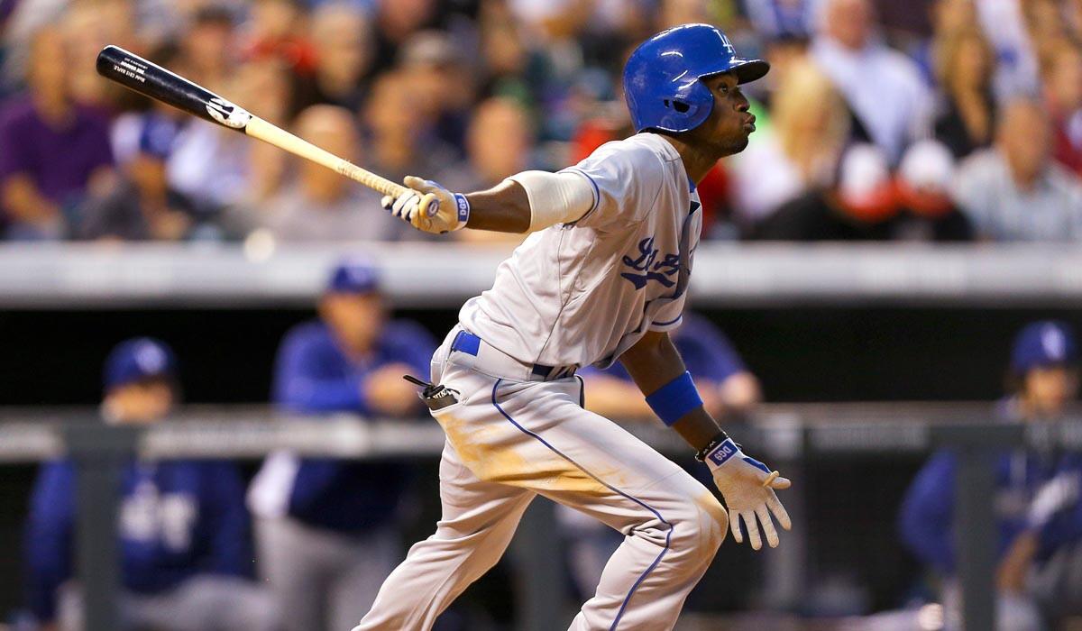 Dodgers second baseman Dee Gordon follows through on his swing after connecting for a two-run single against the Rockies in the sixth inning Friday night in Denver.
