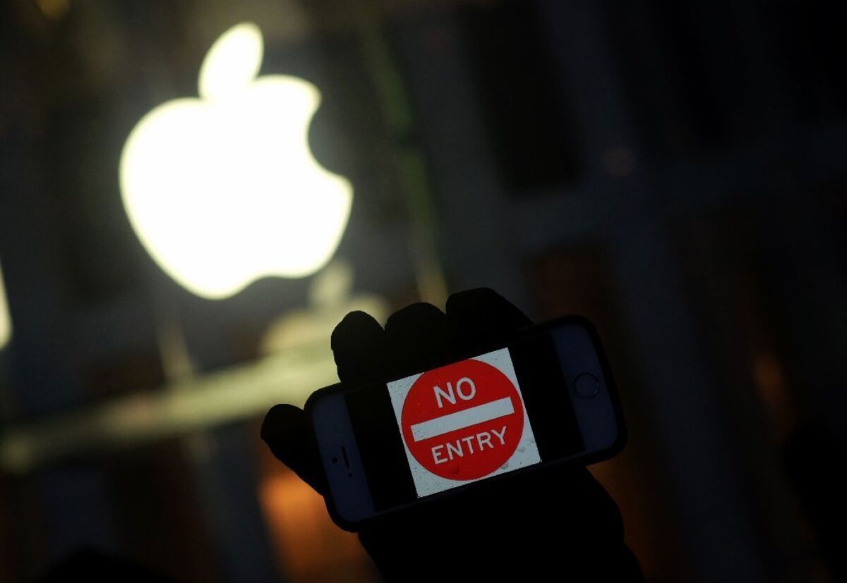An antigovernment protester holding his iPhone with a sign "No Entry" during a demonstration in New York.