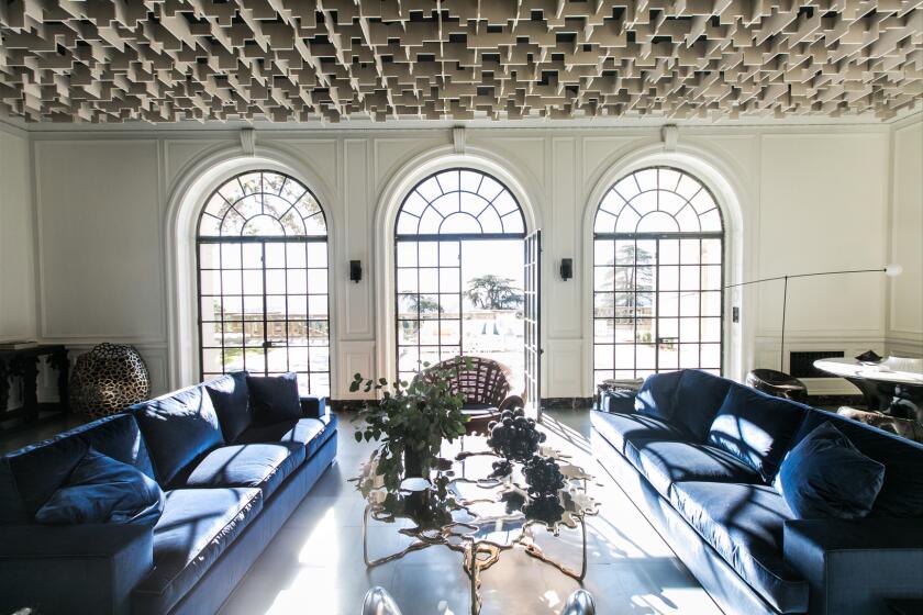 On the first floor of the historic Greystone Mansion in Beverly Hills, designer Oliver M. Furth has re-envisioned the reception hall with a ceiling of recycled plastic and steel tile flooring.