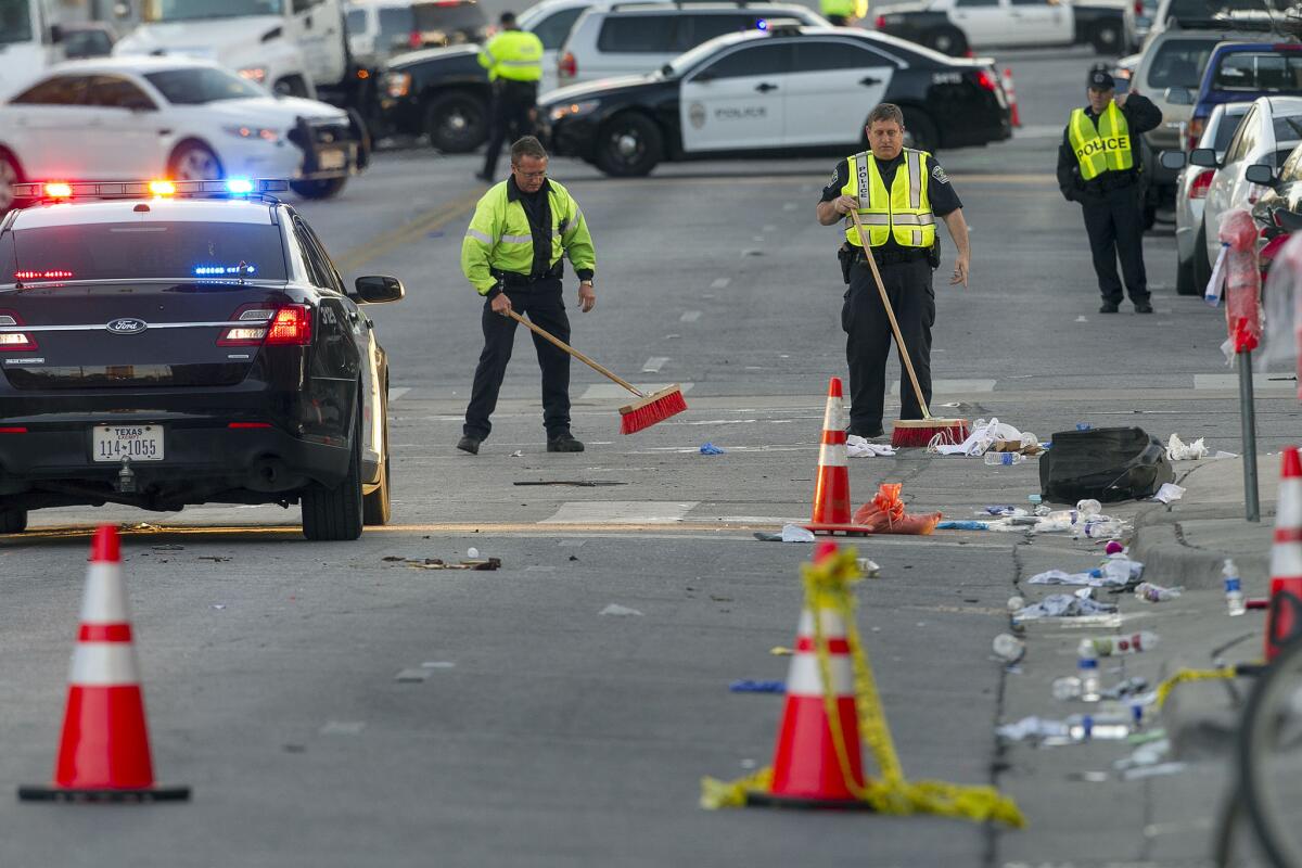 Investigators continue to work the scene on Red River where a man fleeing police drove through a closed street filled with pedestrians killing 2 and injuring 23 more during the SXSW Music Festival held in Austin, Texas, on Thursday, March 13, 2014.