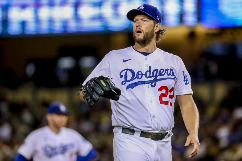 Dodgers starting pitcher Clayton Kershaw walks back to the mound after striking out a batter against the Diamondbacks