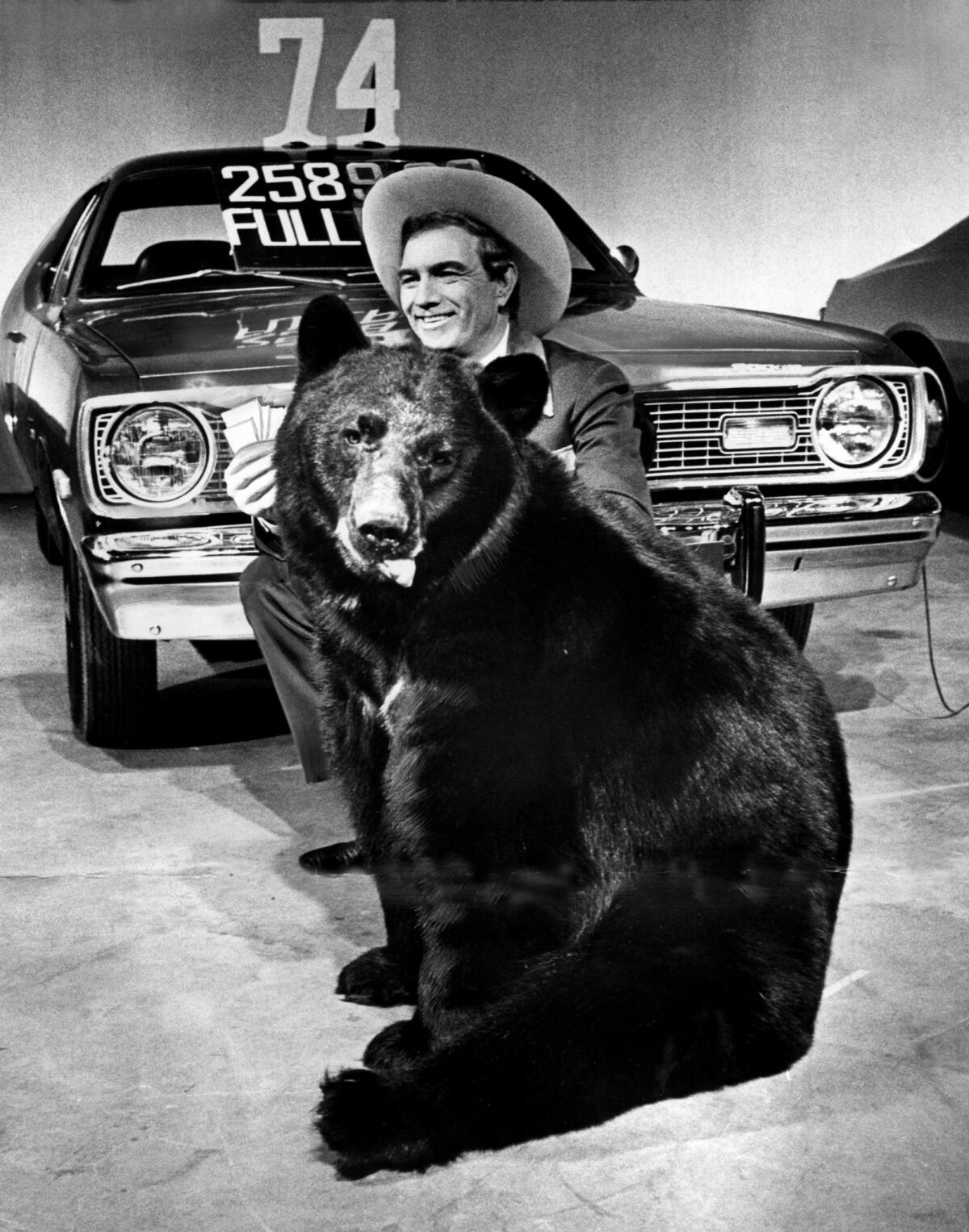 Cal Worthington with a bear — a.k.a. his dog Spot