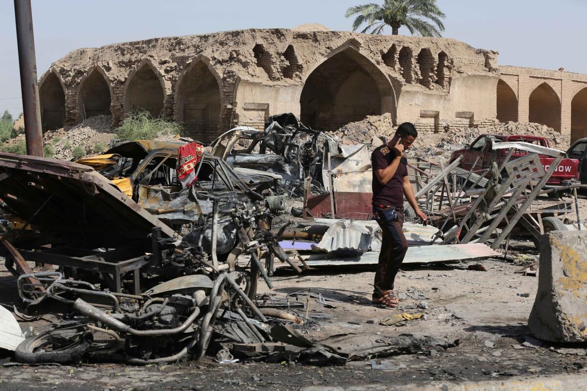 Un civil inspecciona el lugar donde el viernes or la noche se produjo un ataque suicida en un mercado en Jan Beni Saad, 30 kilómetros al noreste de Bagdad, sábado 18 de julio de 2015. El ataque dejó 115 muertos.