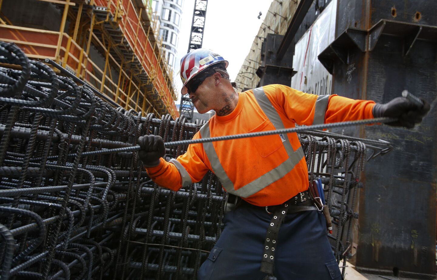 Ironworker Joseph Voll tightens rebar during construction of the 1,100-foot-tall Wilshire Grand tower. It will be the tallest structure west of Chicago, its developers say.