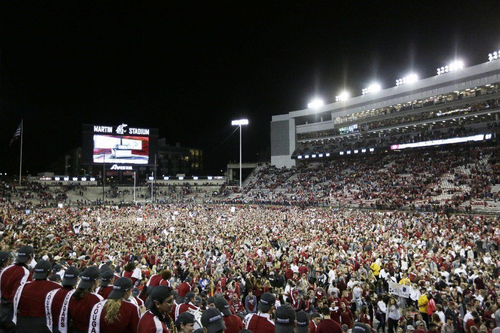 Washington State fans rush the field after win over USC