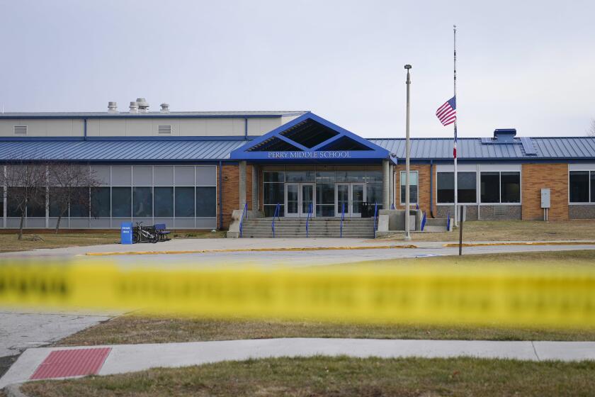 Tape blocks all entrances at the Perry Middle School and High School building on Friday, Jan. 5, 2024, in Perry, Iowa. A day after a shooting sent bullets flying inside the small-town Iowa high school, leaving a sixth grader dead and others wounded, the community of Perry is somber. (AP Photo/Bryon Houlgrave)