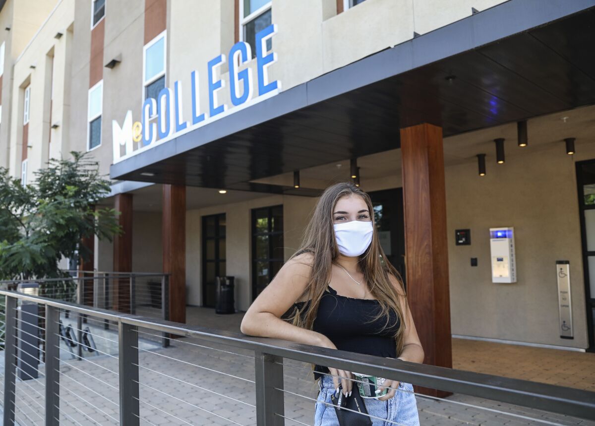Resident Danielle Washington poses for a photo outside the M@College apartments at SDSU.