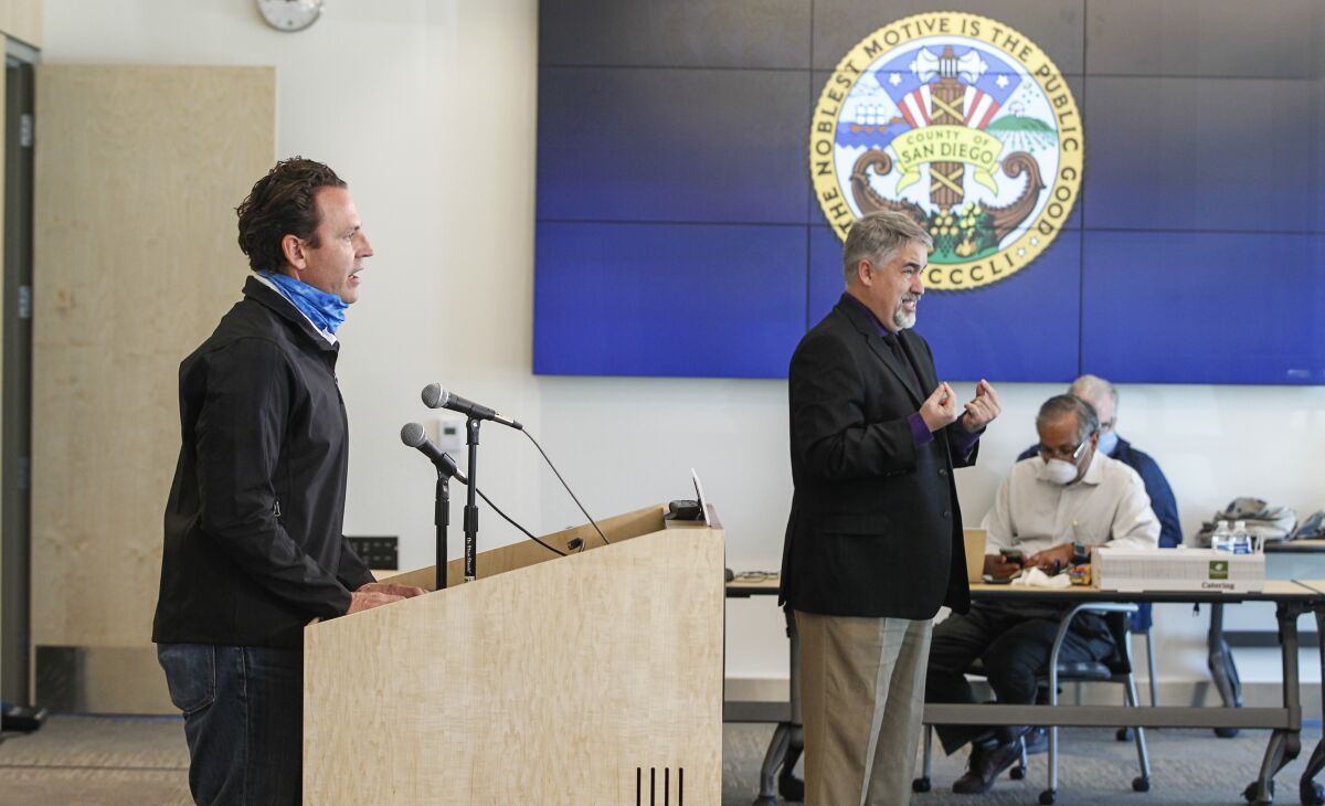 County supervisor Nathan Fletcher (left) speaks during the daily press briefing in April.