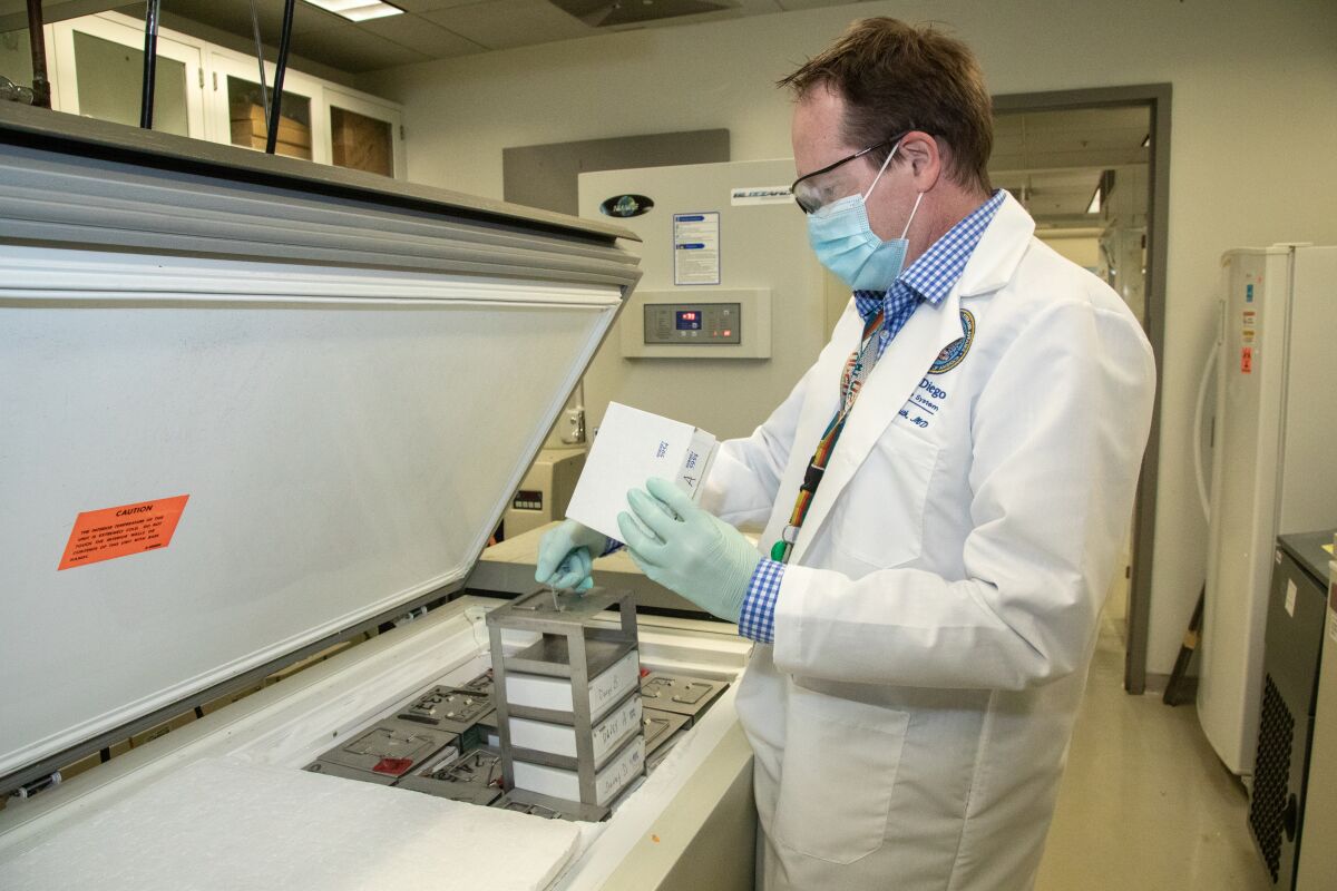 Dr. Davey Smith taking out frozen samples in his lab.