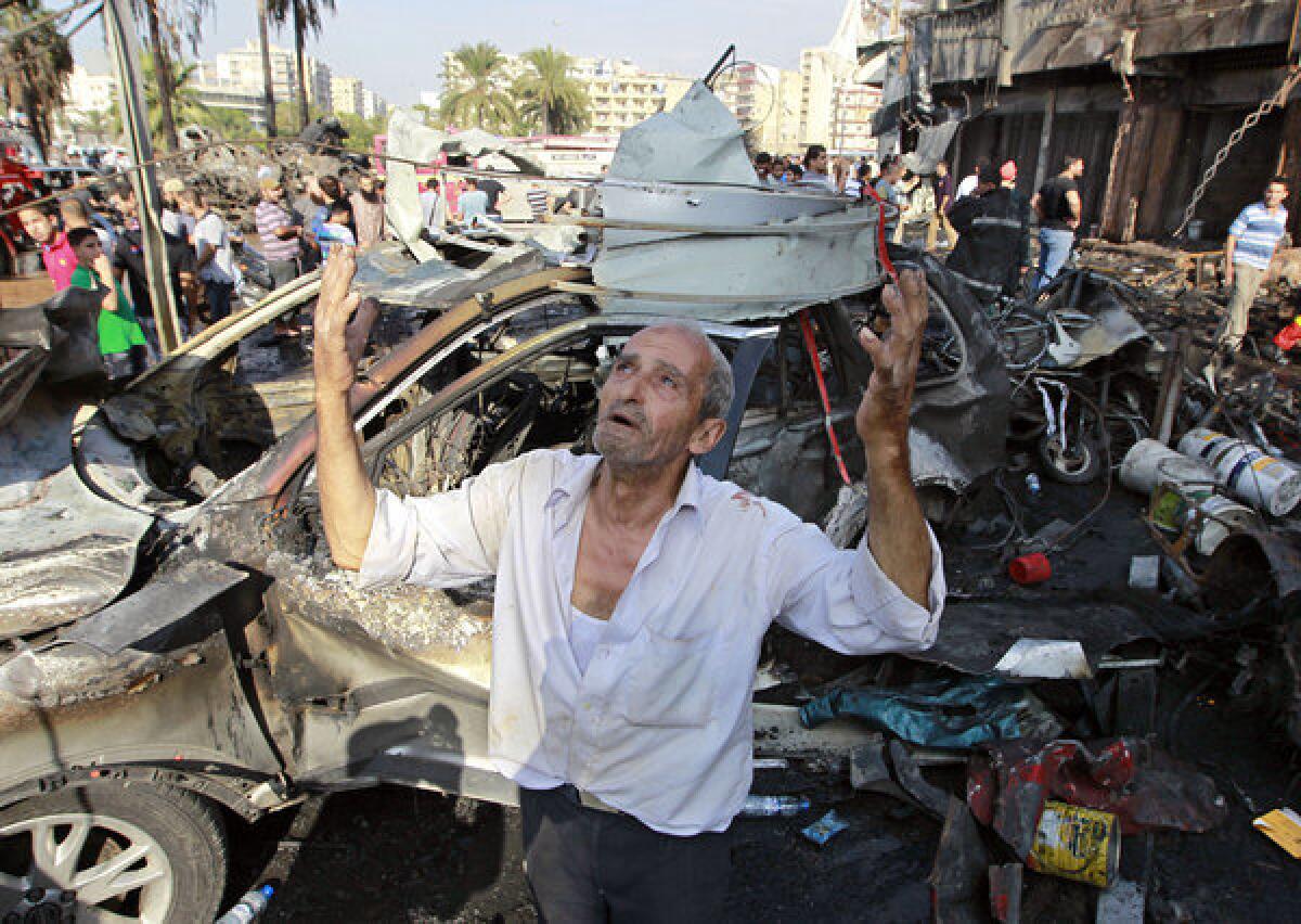 A man recites prayers amid the destruction after an explosion outside a mosque in the northern Lebanese city of Tripoli.