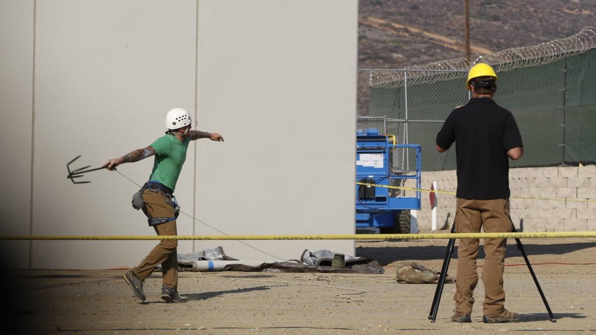 Anti-climb and anti-dig testing takes place at the border wall prototype site in Otay Mesa, Calif.