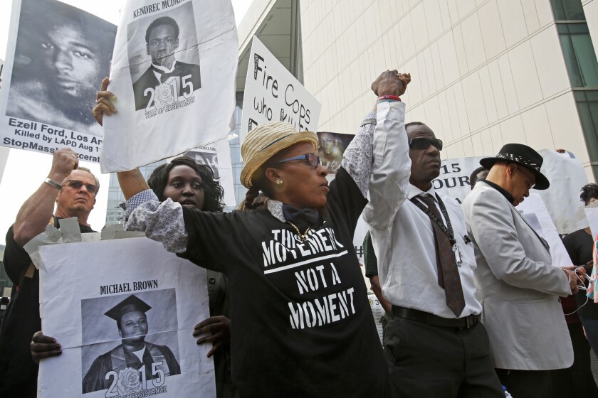 #BlackLivesMatter members hold a news conference outside LAPD headquarters in Los Angeles after four representatives from the group met with Chief Charlie Beck to voice their concerns about fatal police shootings.