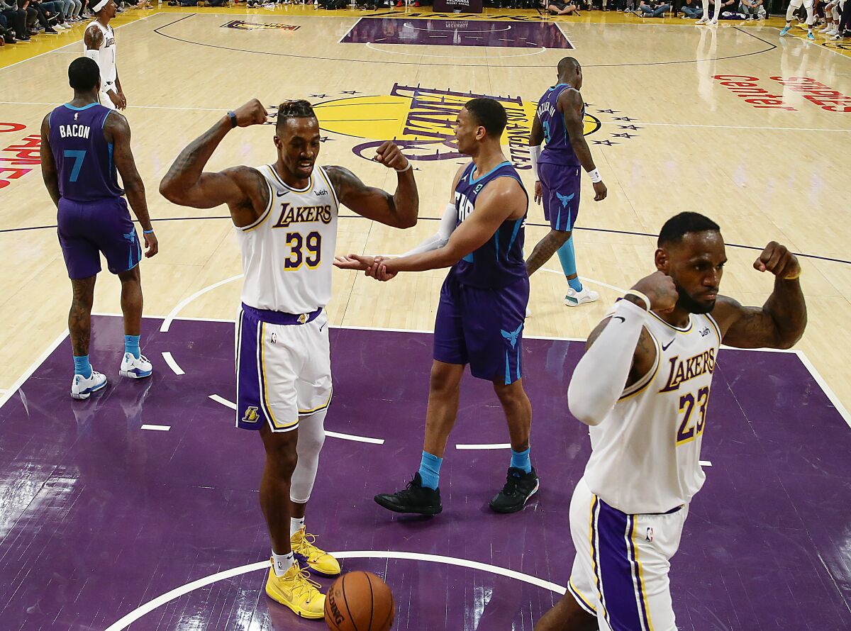 Lakers center Dwight Howard, left, and teammate LeBron James flex after a second-half basket.