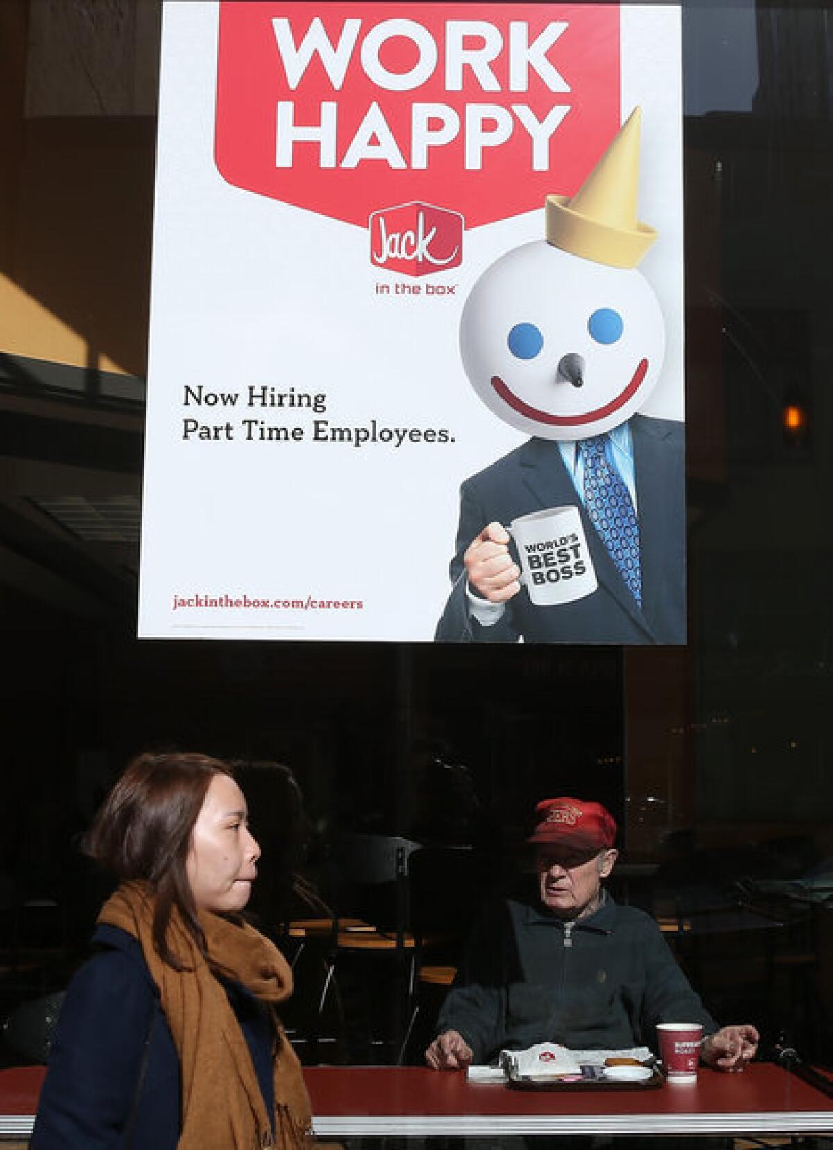 A sign advertising jobs in the window of a Jack in the Box restaurant in San Francisco.