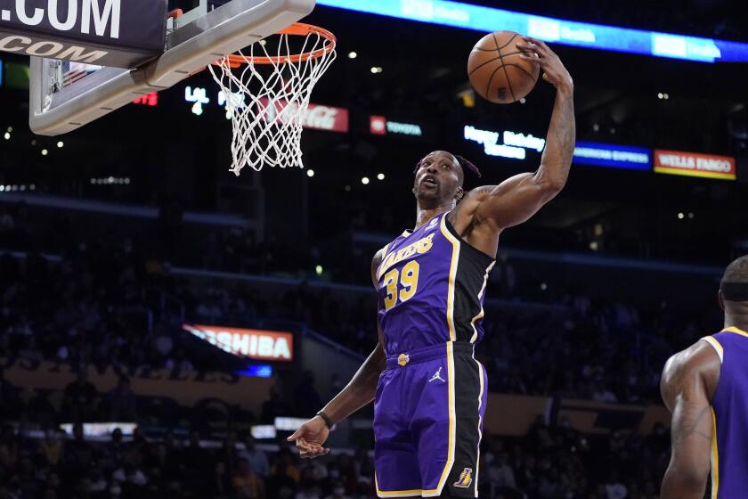 Los Angeles Lakers center Dwight Howard grabs a rebound during the first half of an NBA basketball game against the Phoenix Suns Friday, Oct. 22, 2021, in Los Angeles. (AP Photo/Marcio Jose Sanchez)