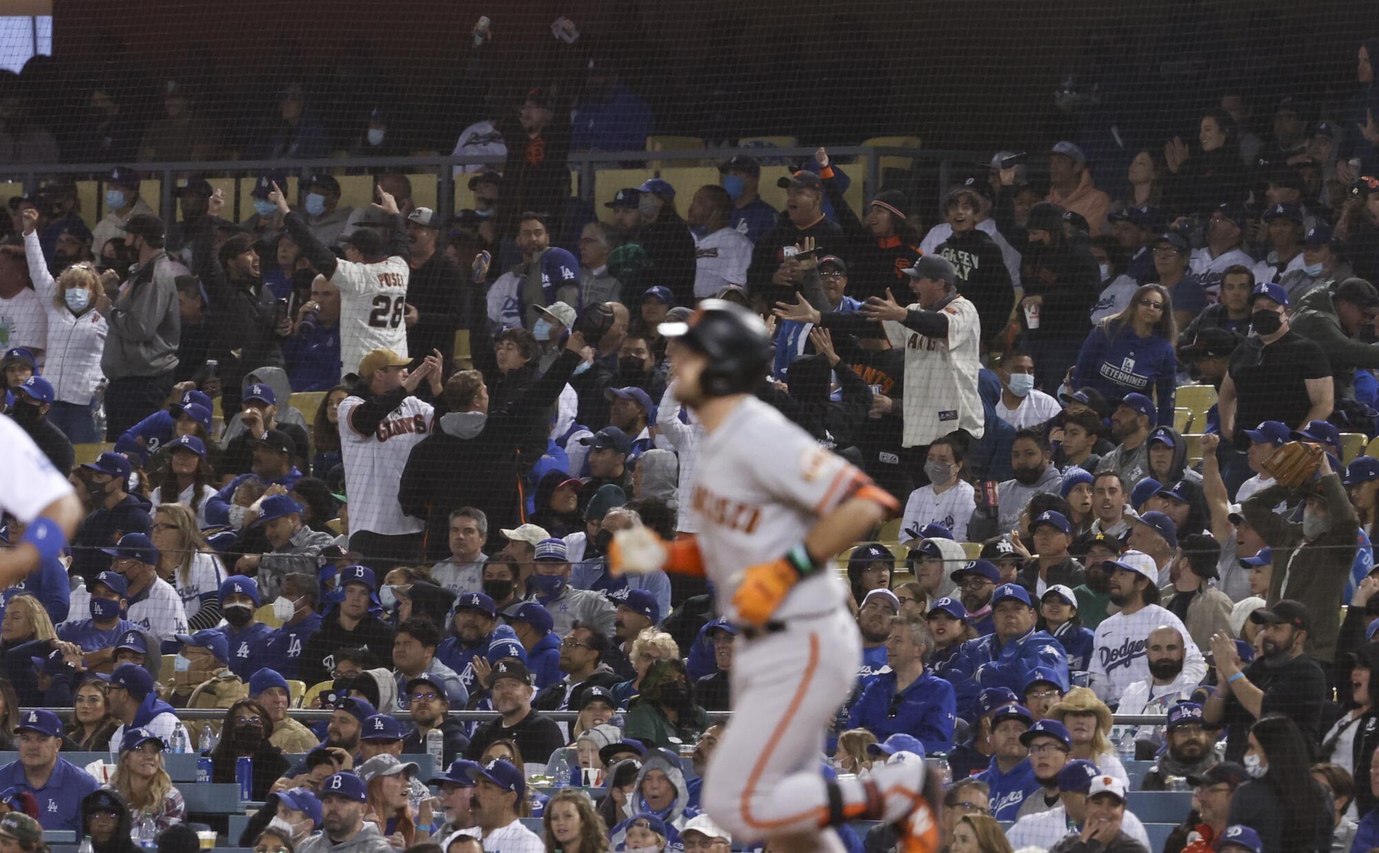 San Francisco Giants fans celebrate after a solo home run by Evan Longoria