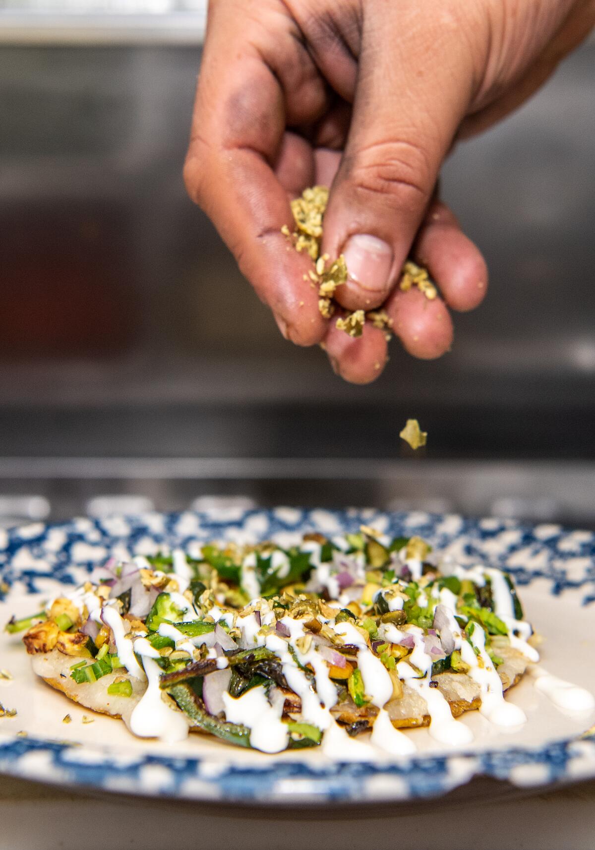 The popular rajas taco from Masataco features pasilla peppers, squash and pepitas.