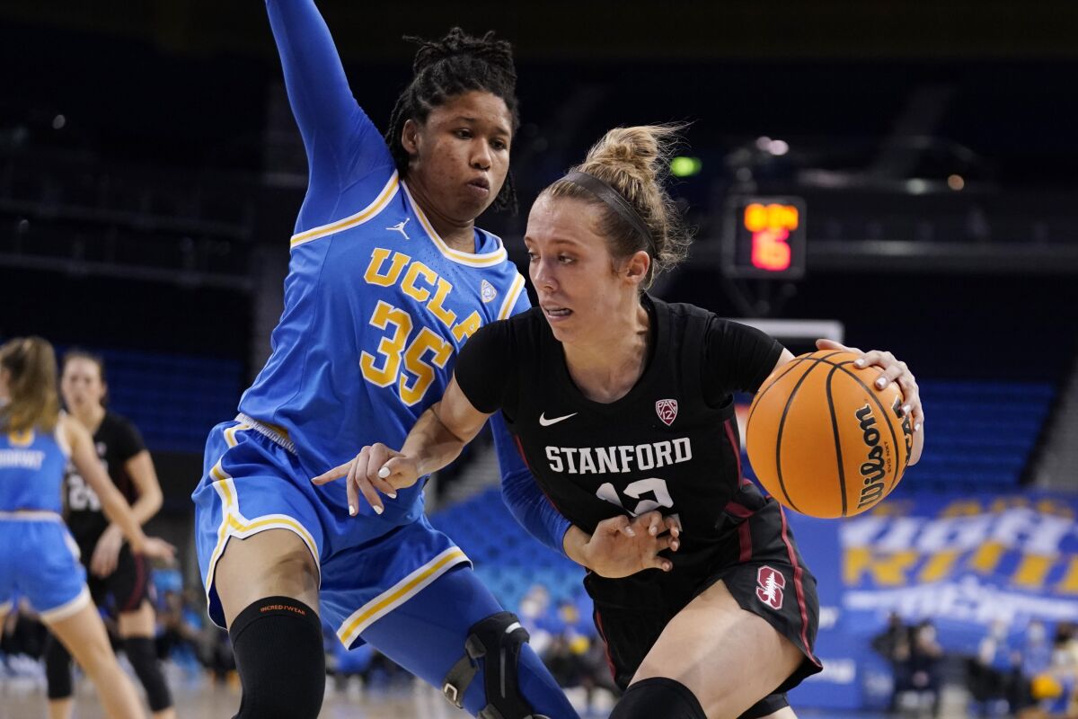 Stanford guard Lexie Hull, right, dribbles next to UCLA guard Camryn Brown (35) during the second half of an NCAA college basketball game Thursday, Feb. 3, 2022, in Los Angeles. (AP Photo/Marcio Jose Sanchez)