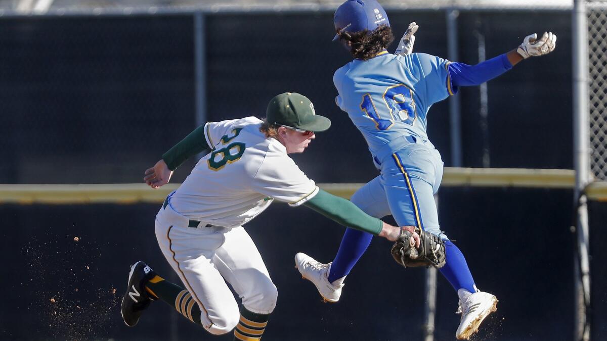 Edison High's Blake Morton, left, tags out La Mirada's Jimmy Blumberg at first base during the third inning in the Downey Tournament on Wednesday.