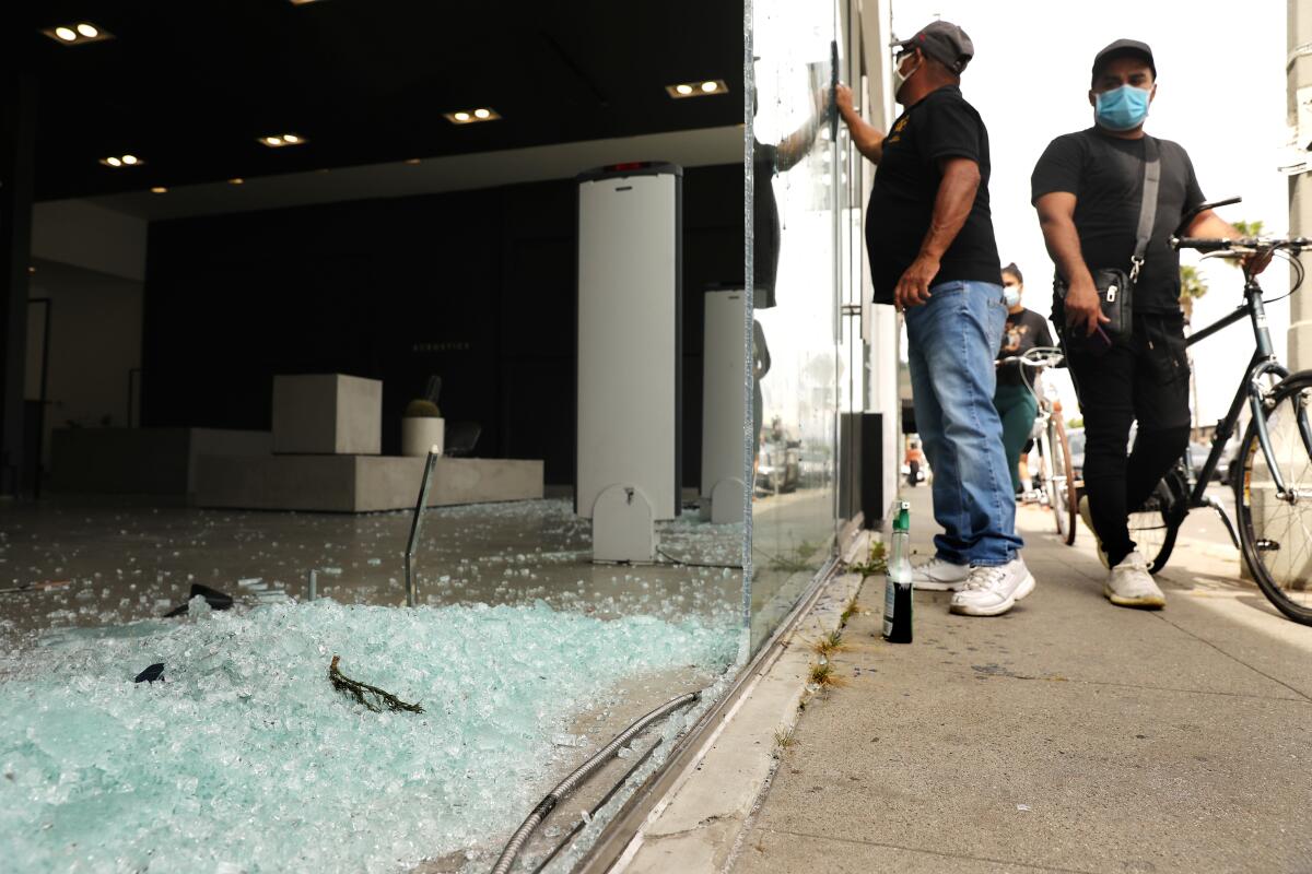Shattered glass fills a storefront on Melrose Avenue on Sunday after a night of looting in the popular shopping area.