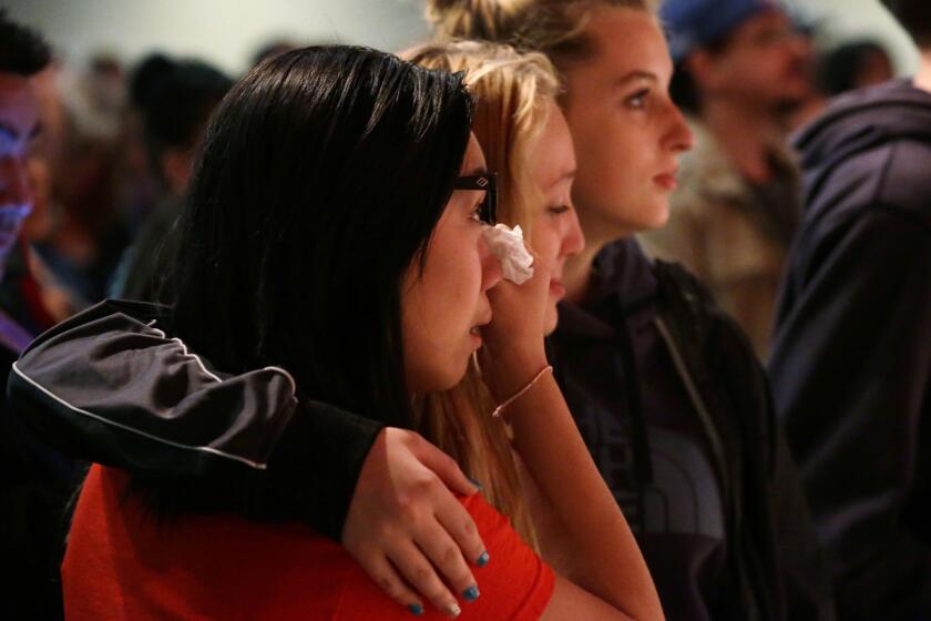 Mourners attend a vigil at the Grove Church in Marysville, Wash., Friday night for victims of the shooting at Marysville-Pilchuck High School.