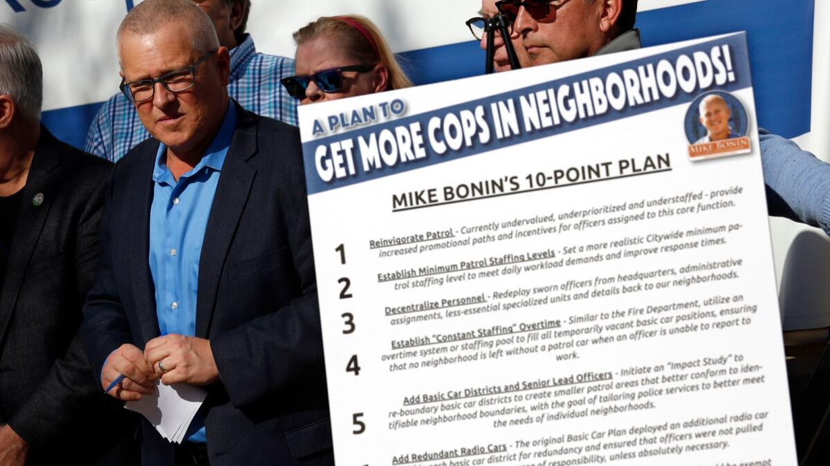 Los Angeles City Councilman Mike Bonin stands next to a poster last month illustrating his 10-point plan to add more patrol officers to L.A. neighborhoods.