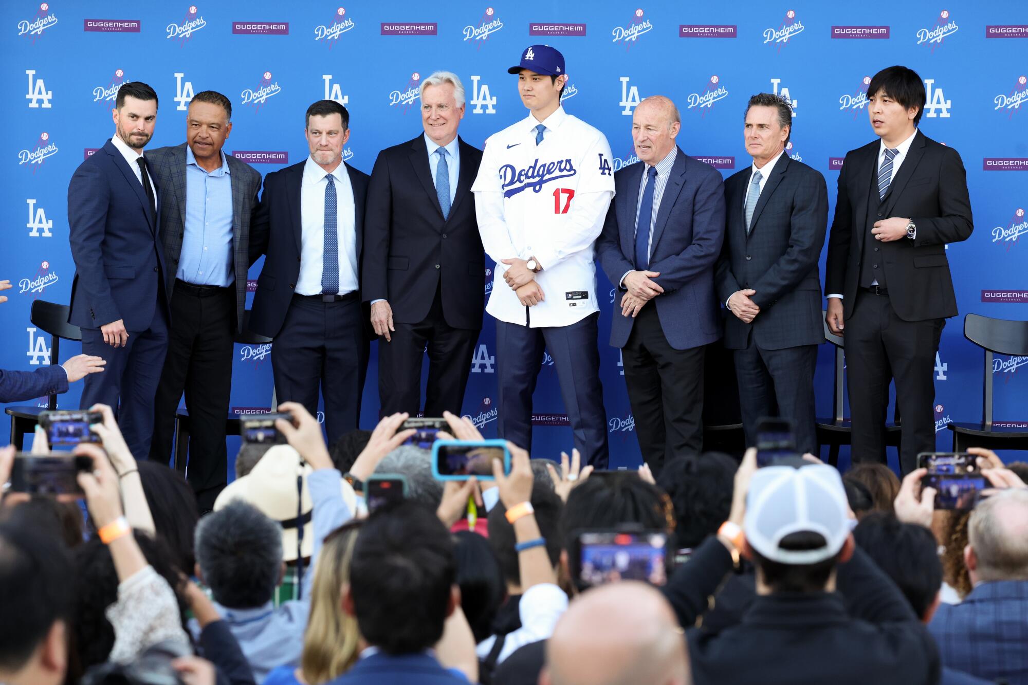 Shohei Ohtani stands with members of the Dodgers' front office after formally being introduced as a Dodger.