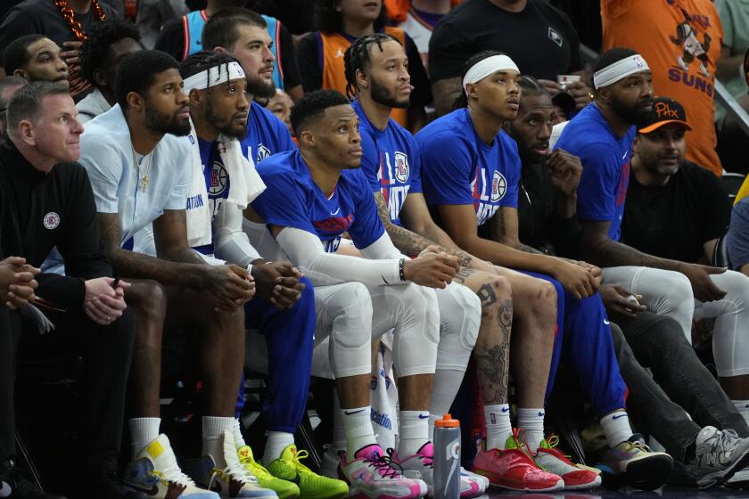 Clippers bench watches during the second half of Game 5 of a first-round NBA basketball playoff series against the Suns