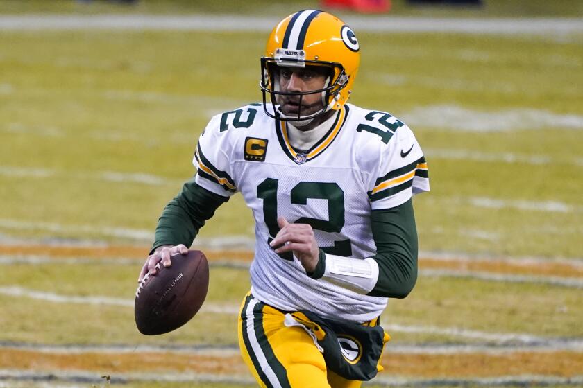 Green Bay Packers' Aaron Rodgers runs during the first half of an NFL football game against the Chicago Bears.