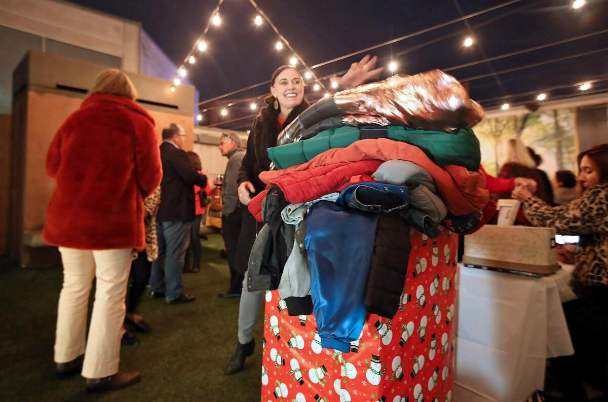 Guests add to the pile of coats and jackets donated during Thursday's event.