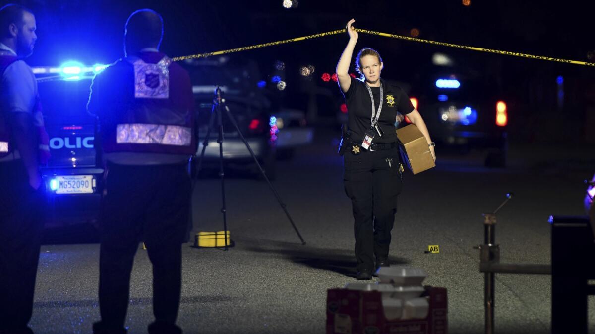 A member of the Florence County Sheriff’s Office leaves the crime scene in Florence, S.C. where seven law enforcement officers were shot, one fatally, on Oct. 3.