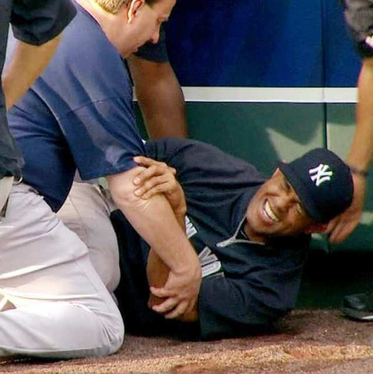 New York Yankees' Mariano Rivera grimaces after twisting his right knee shagging fly balls during batting practice on Thursday evening.