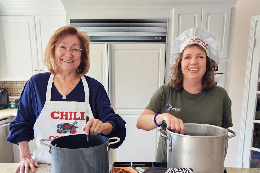 Trying out recipes for the Kiwanis Club of Poway’s inaugural Chili Challenge are Chair Mona Randel and club President Heather Skale.