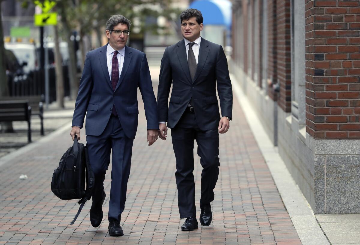 Gordon Caplan, right, arrives at federal court May 21 in Boston. He was sentenced Oct. 3 in the college admissions scandal.