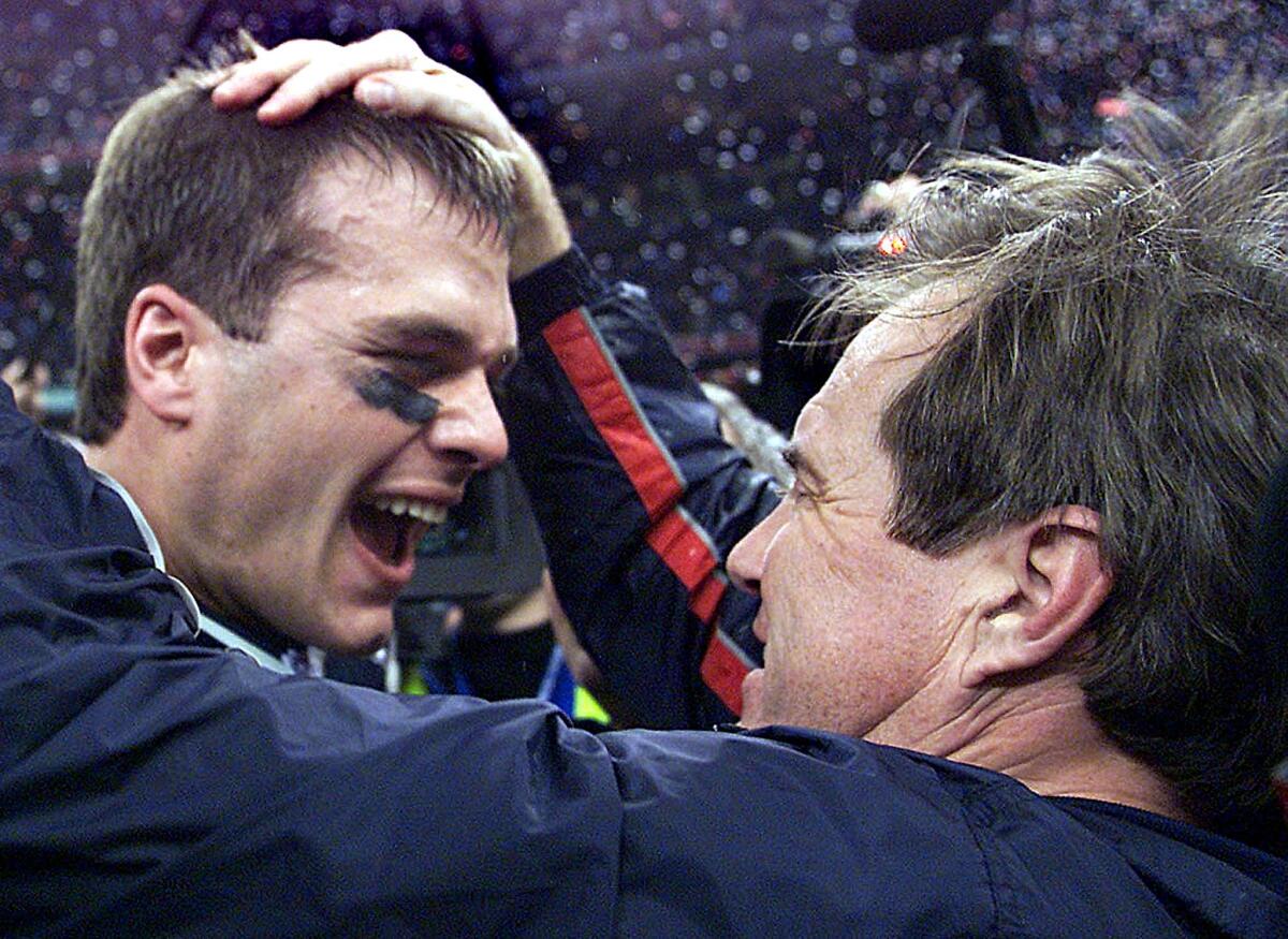 New England Patriots quarterback Tom Brady celebrates with coach Bill Belichick after defeating the St. Louis Rams in Super Bowl XXXVI on Feb. 3, 2002.